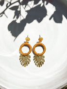 Gold tropical leaf earrings with gold-tone leaf pendants, handmade in Guatemala
