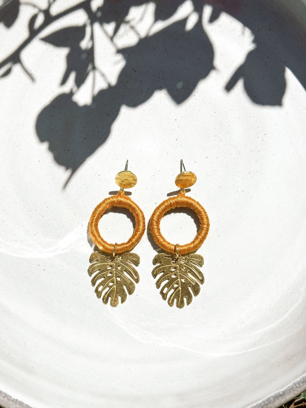 Gold tropical leaf earrings with gold-tone leaf pendants, handmade in Guatemala