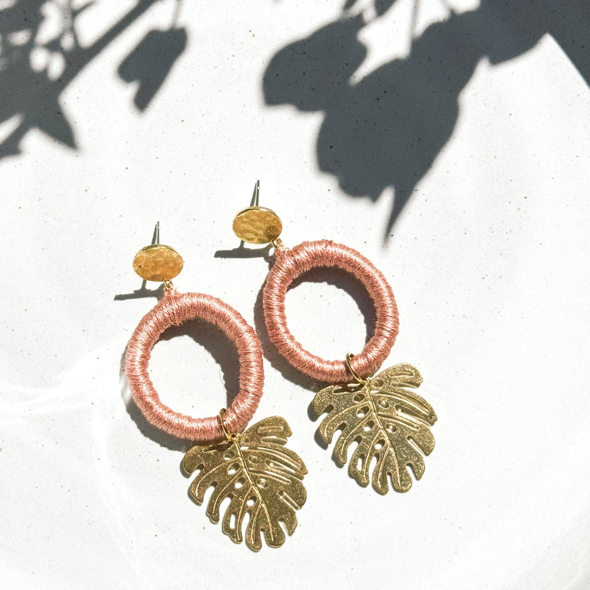 Nude Vida Tropical Earrings with cotton-wrapped hoops and brass tropical leaf pendants. Lightweight, handmade in Guatemala for Vida Maya.